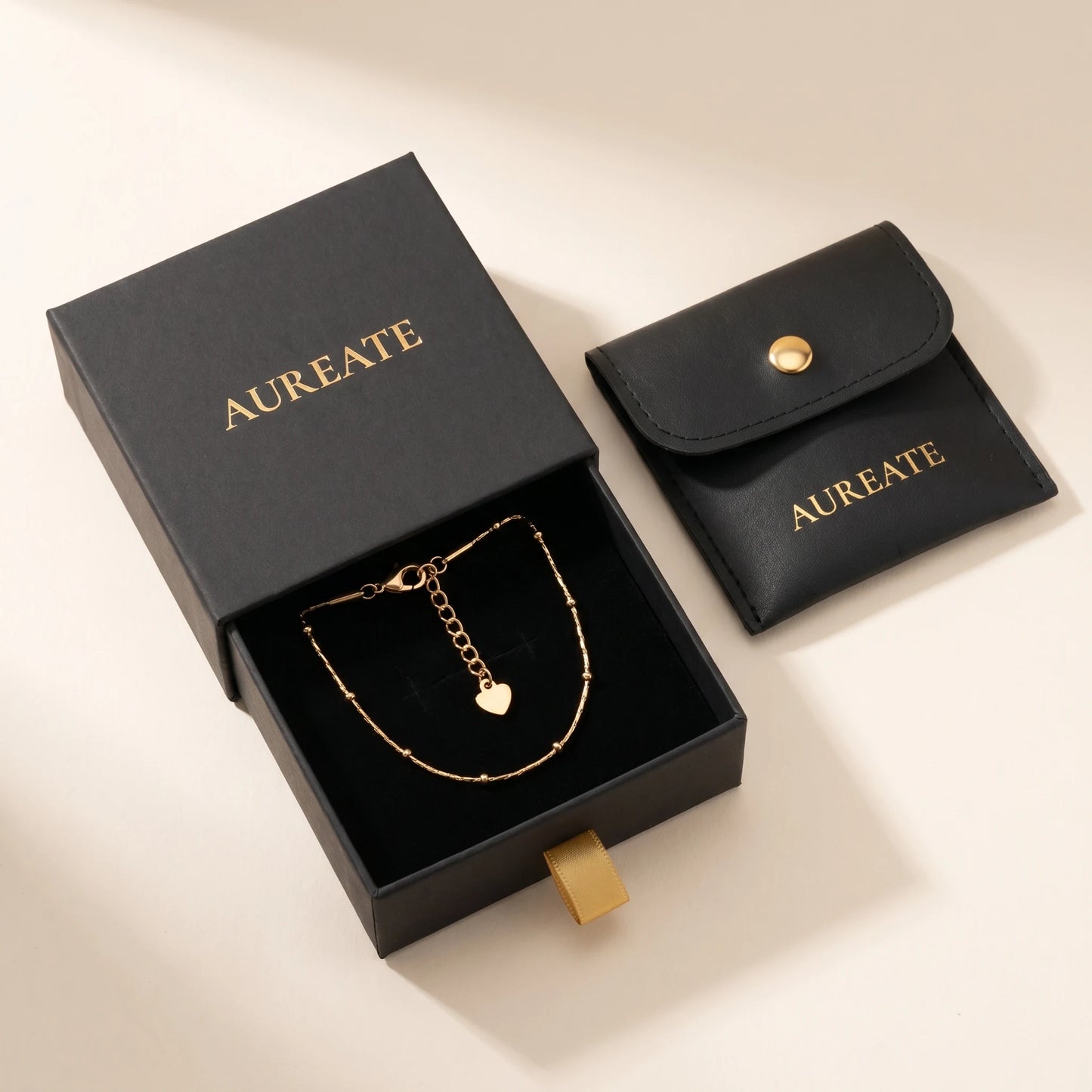 AUREATE matte black gift box gold logo gold ribbon tab leather pouch satellite beaded gold anklet inside