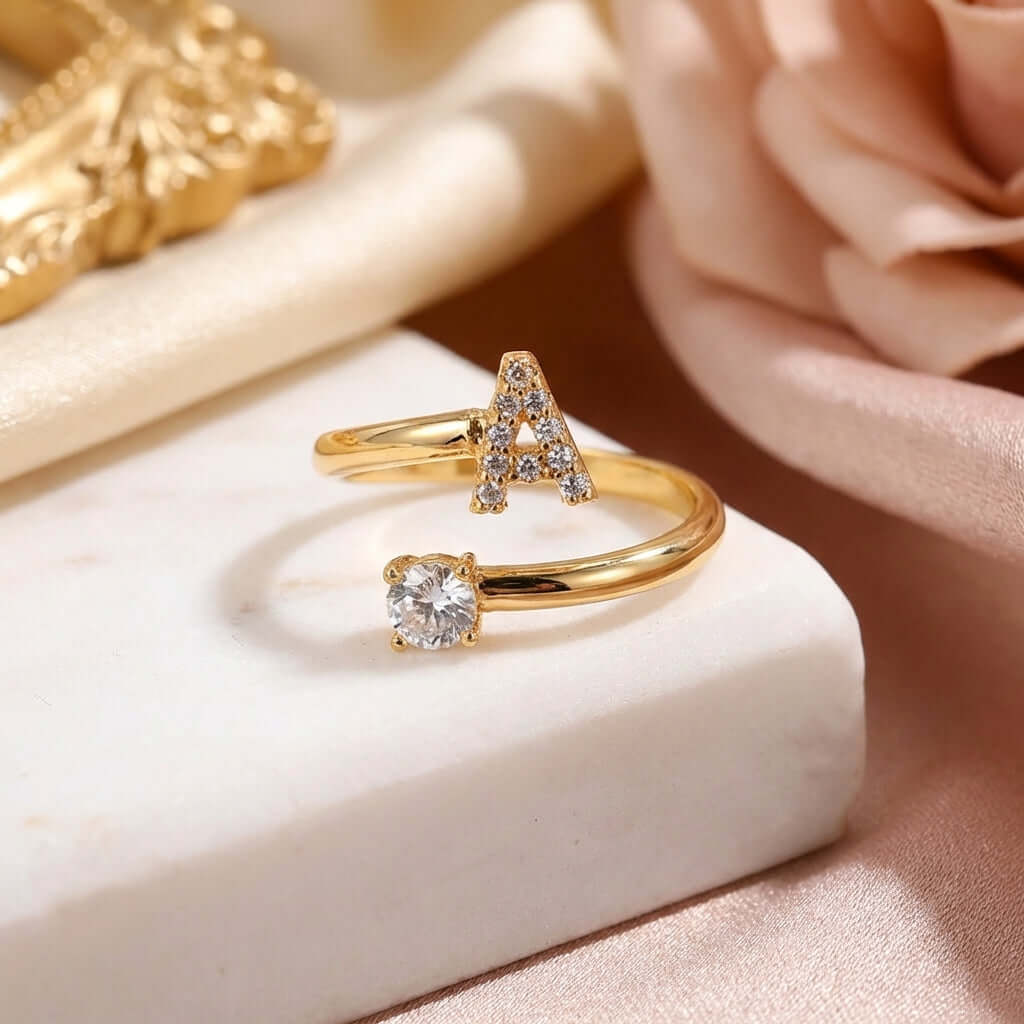 Iced Initial Signet Ring by AUREATE featuring sparkling 'A' design and a diamond-like stone.