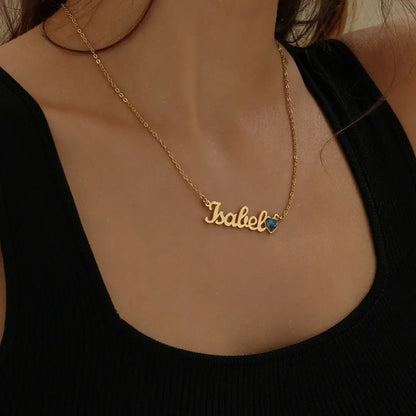 Birthstone Personalised Name Necklace featuring a gold nameplate with a blue gemstone, styled by AUREATE.