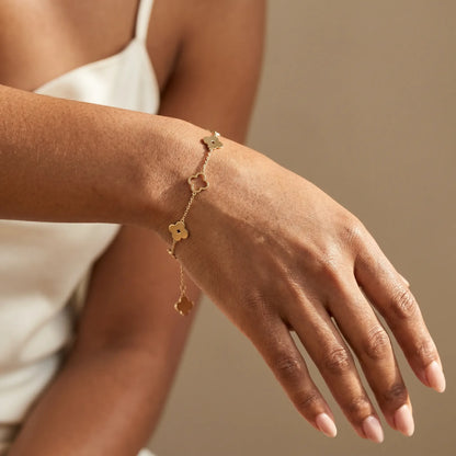 Four-leaf clover bracelet on dorsal wrist studio worn close-up - gold