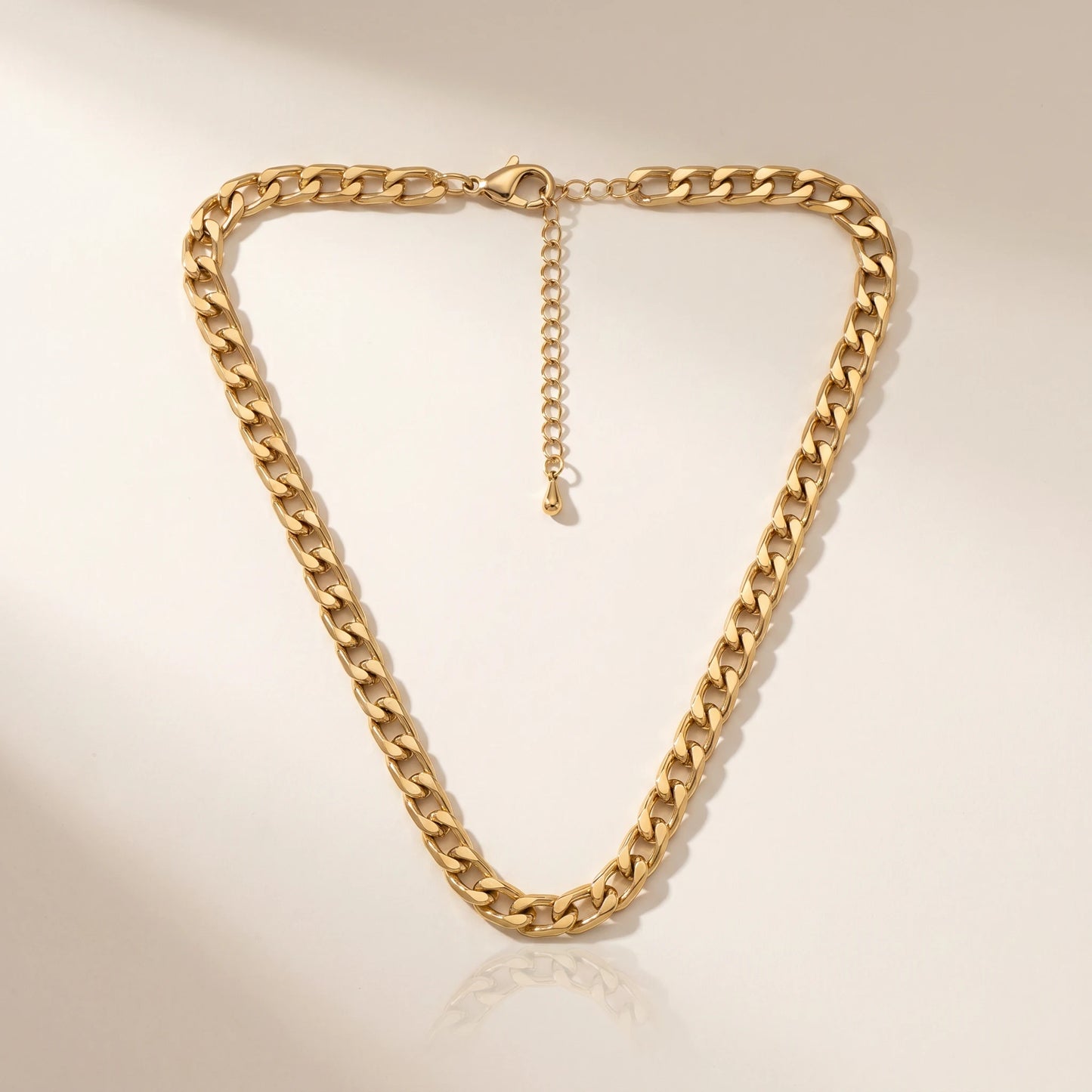 Bold curb chain necklace gold packshot inverted V drape with clasp