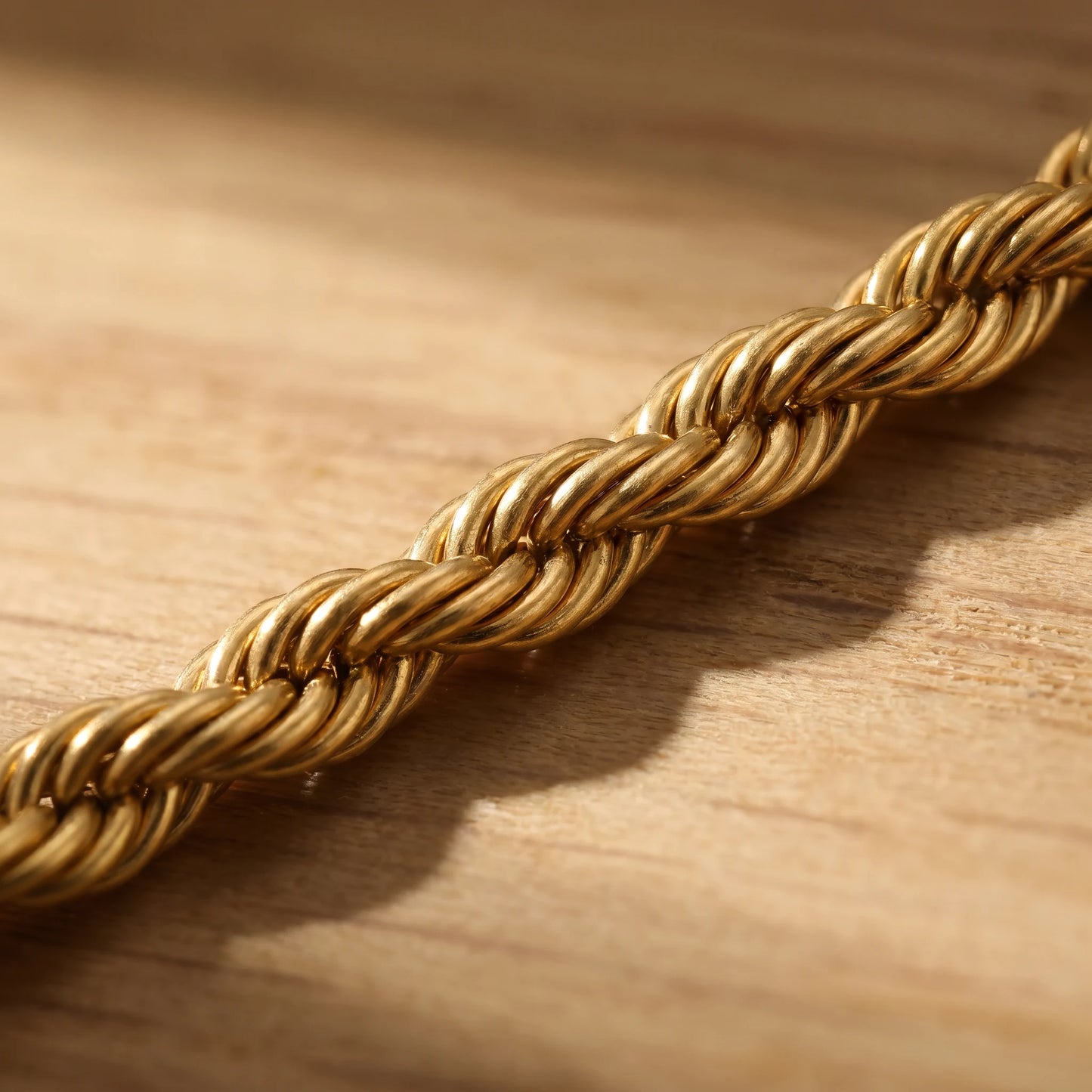 Macro detail of gold rope twist chain helical spiral pattern