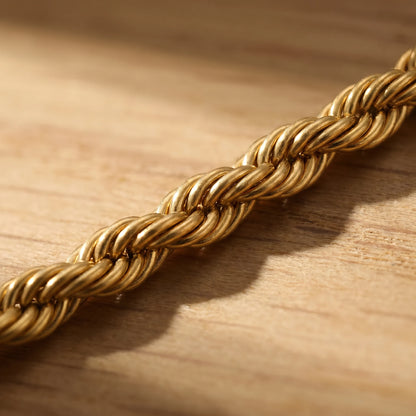 Macro detail of gold rope twist chain helical spiral pattern