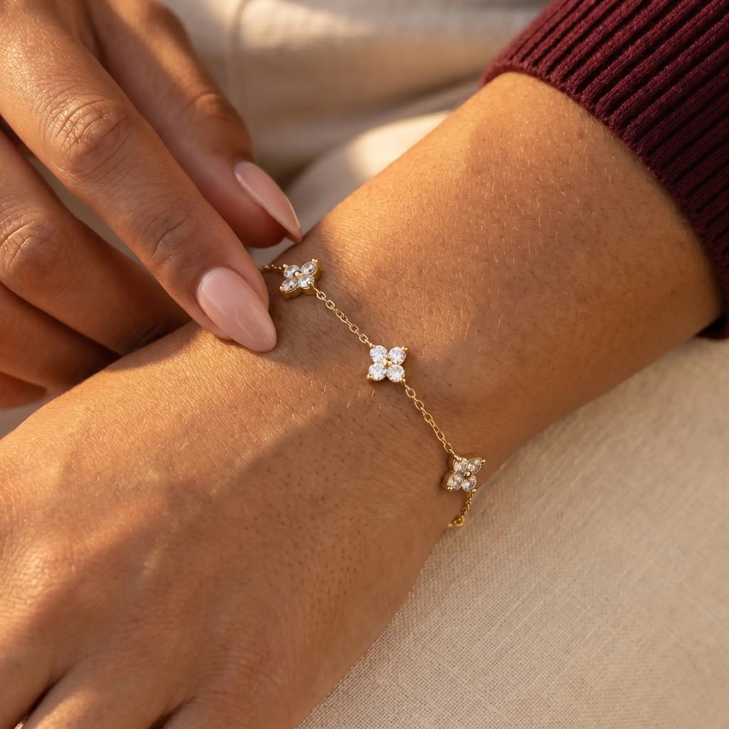 Gold clover bracelet intimate hand-to-jewelry tactile fingertip touching charm