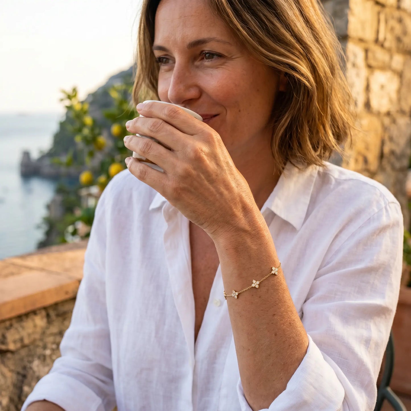 Gold clover bracelet aspirational profile Amalfi terrace French Parisienne 42yo coffee