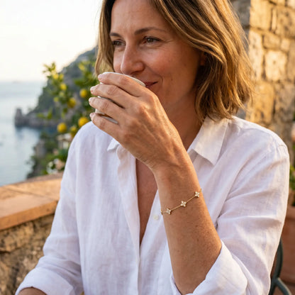 Gold clover bracelet aspirational profile Amalfi terrace French Parisienne 42yo coffee