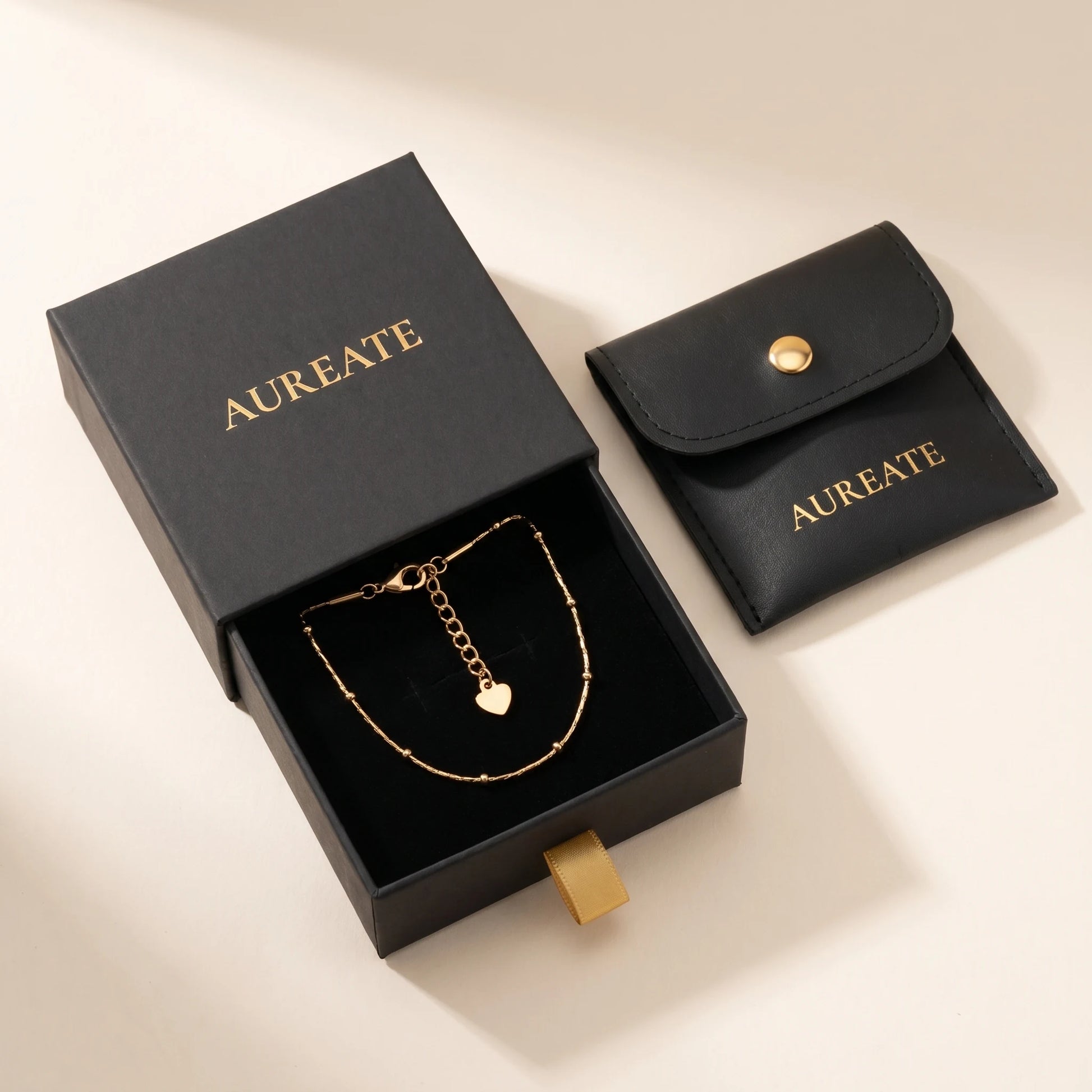 AUREATE matte black gift box gold logo gold ribbon tab leather pouch satellite beaded gold anklet inside