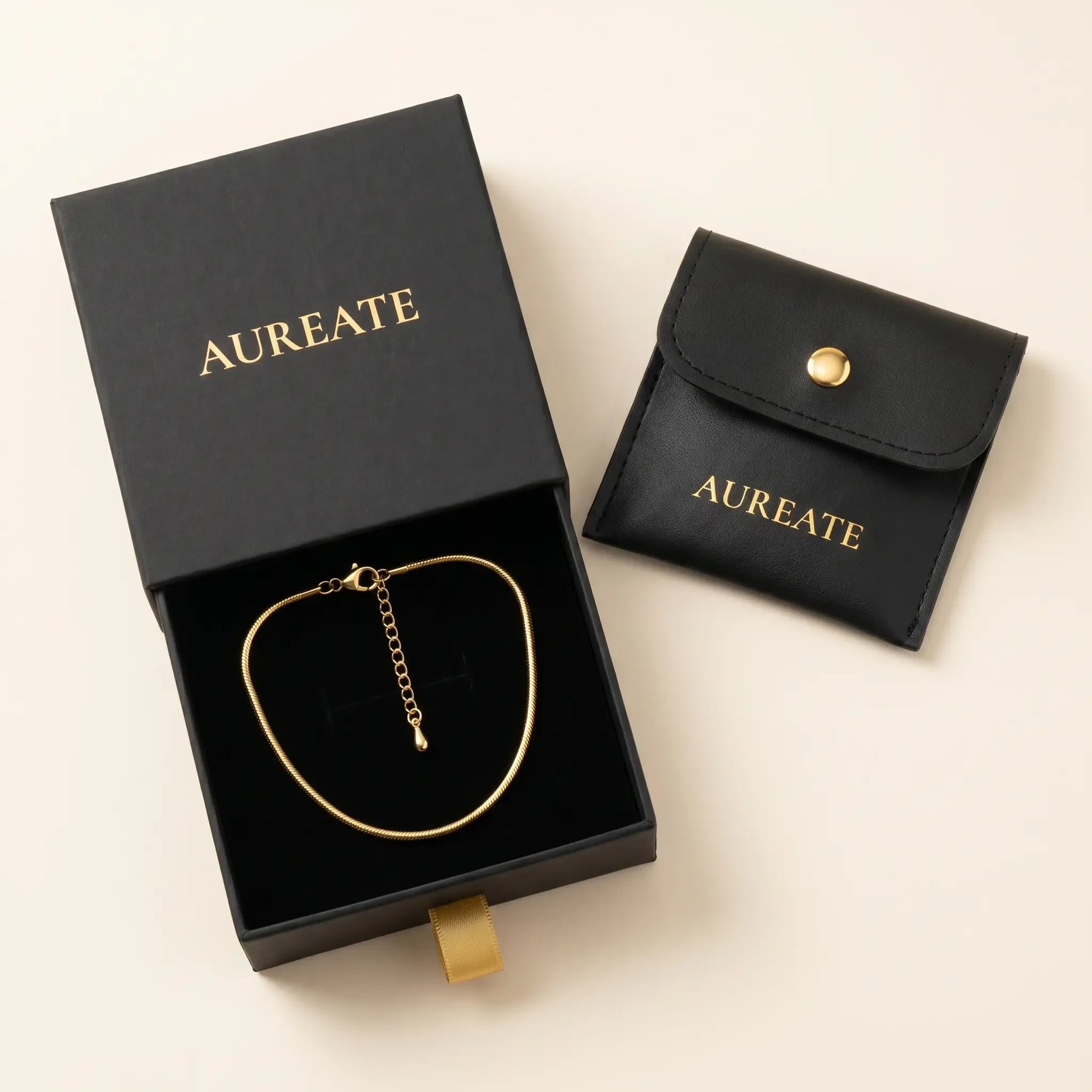 AUREATE gift box with gold snake anklet inside slide drawer and leather pouch