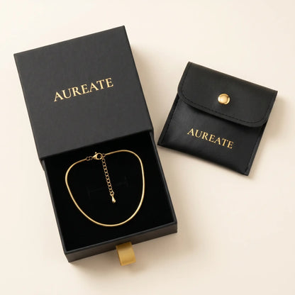 AUREATE gift box with gold snake anklet inside slide drawer and leather pouch
