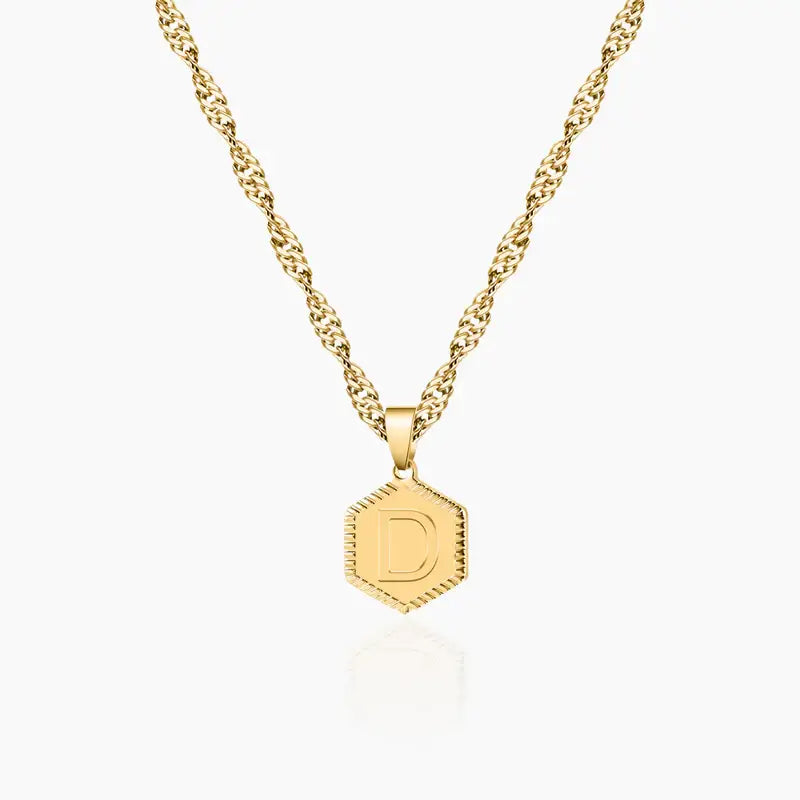 Hexagon Initial Necklace by AUREATE featuring a gold twisted chain and hexagon pendant with letter D.