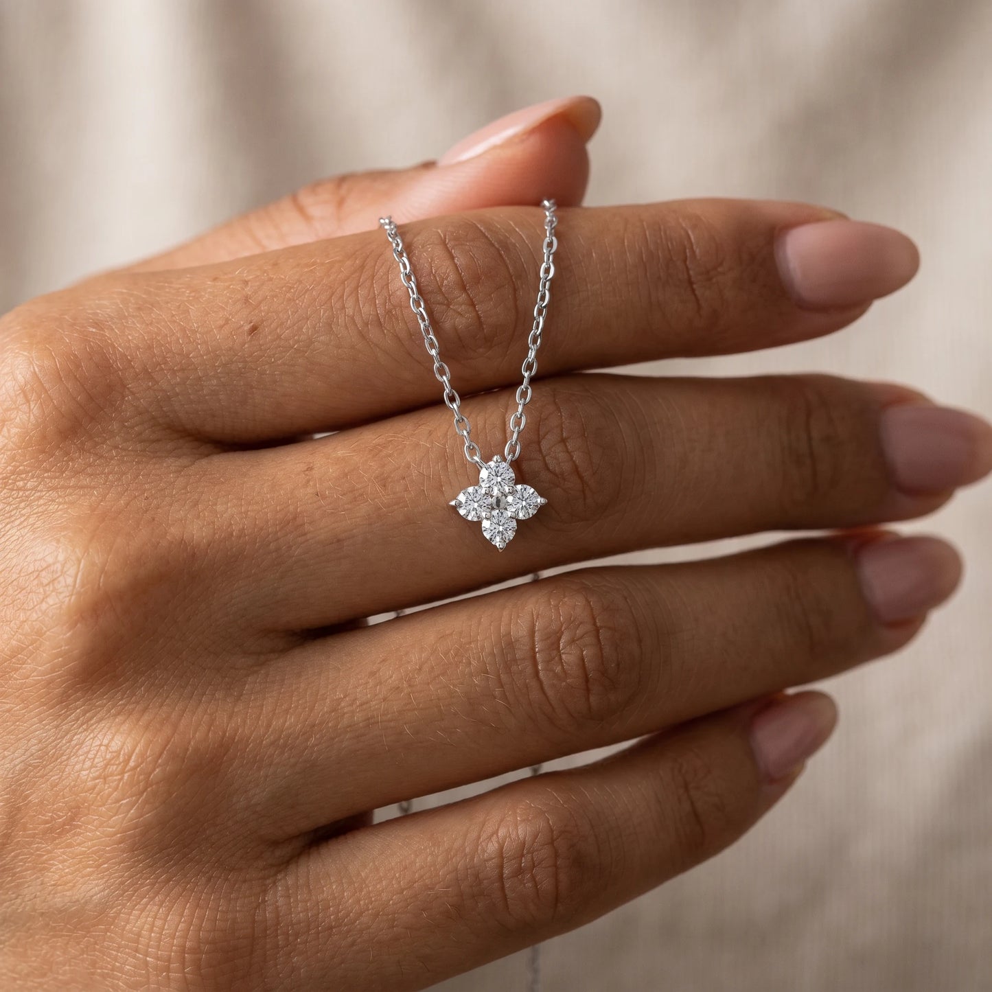 Diamond cluster necklace silver hand held intimate close up dorsal