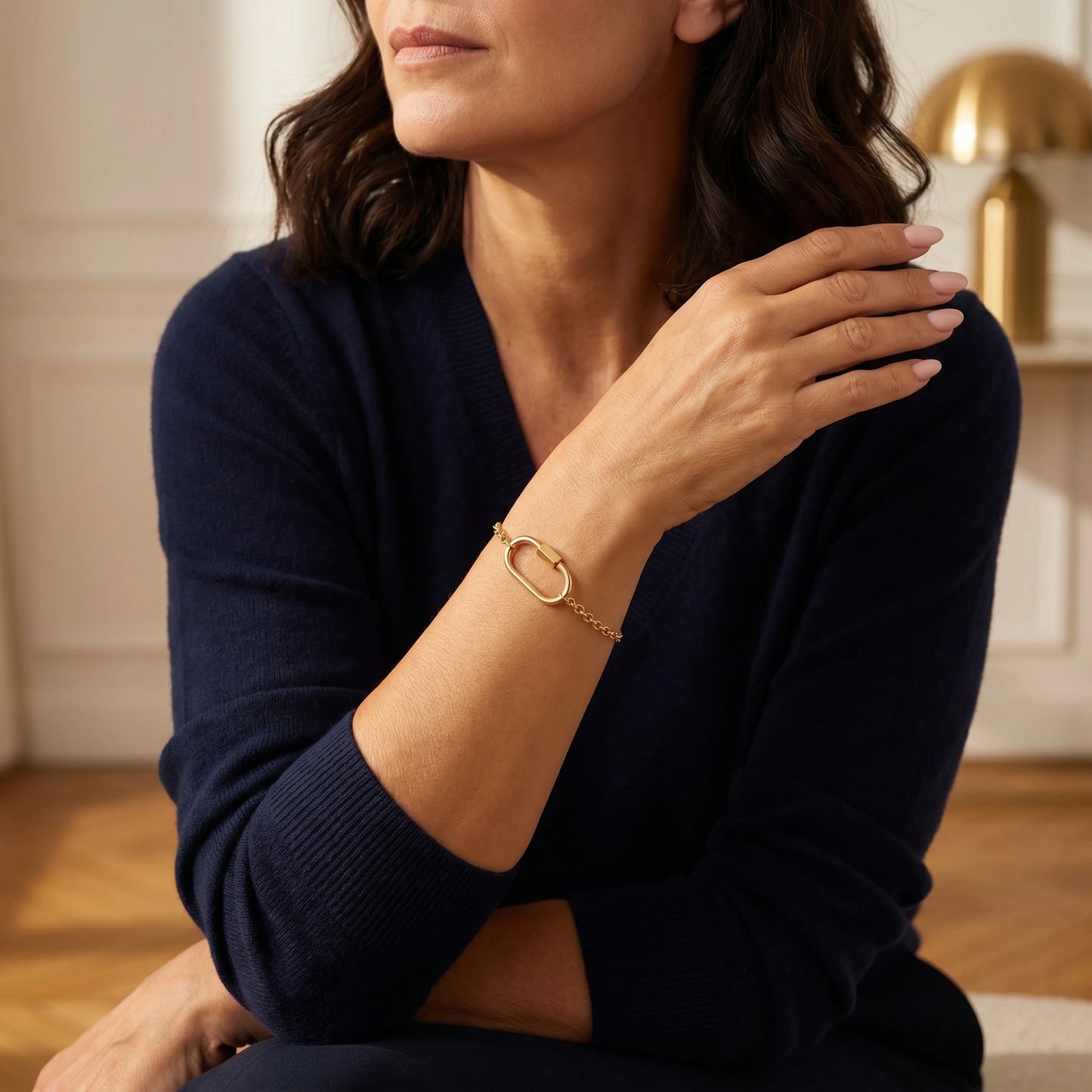 Oval lock cable bracelet gold 18K — three-quarter portrait worn