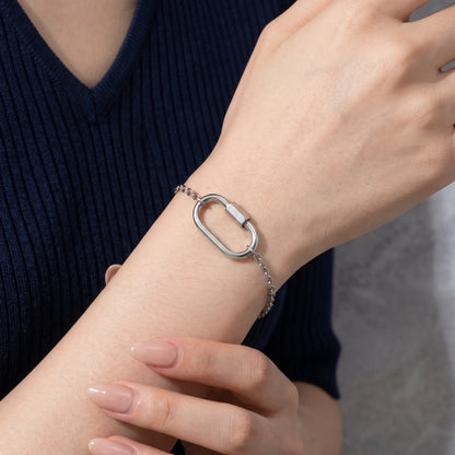 Oval lock cable bracelet silver — worn dorsal wrist close-up