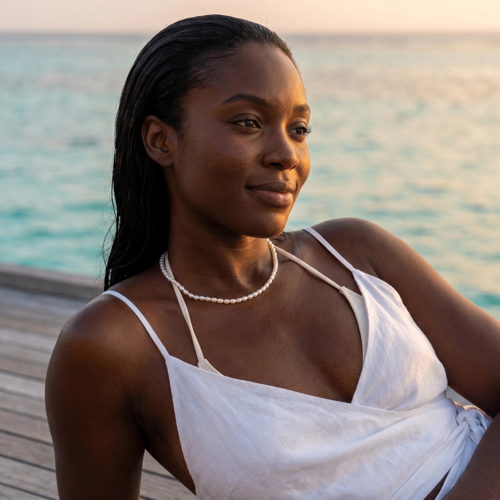 Pearl necklace Maldives overwater bungalow sunset