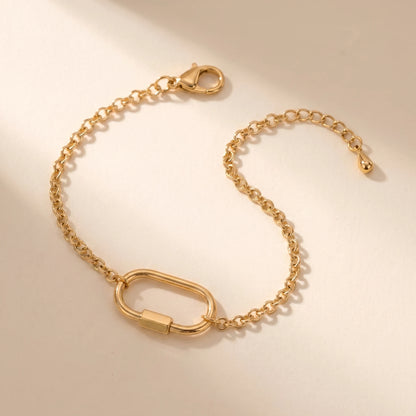 Gold cable chain bracelet with oval carabiner lock pendant - packshot 18K gold plated stainless steel with 3cm cable extender