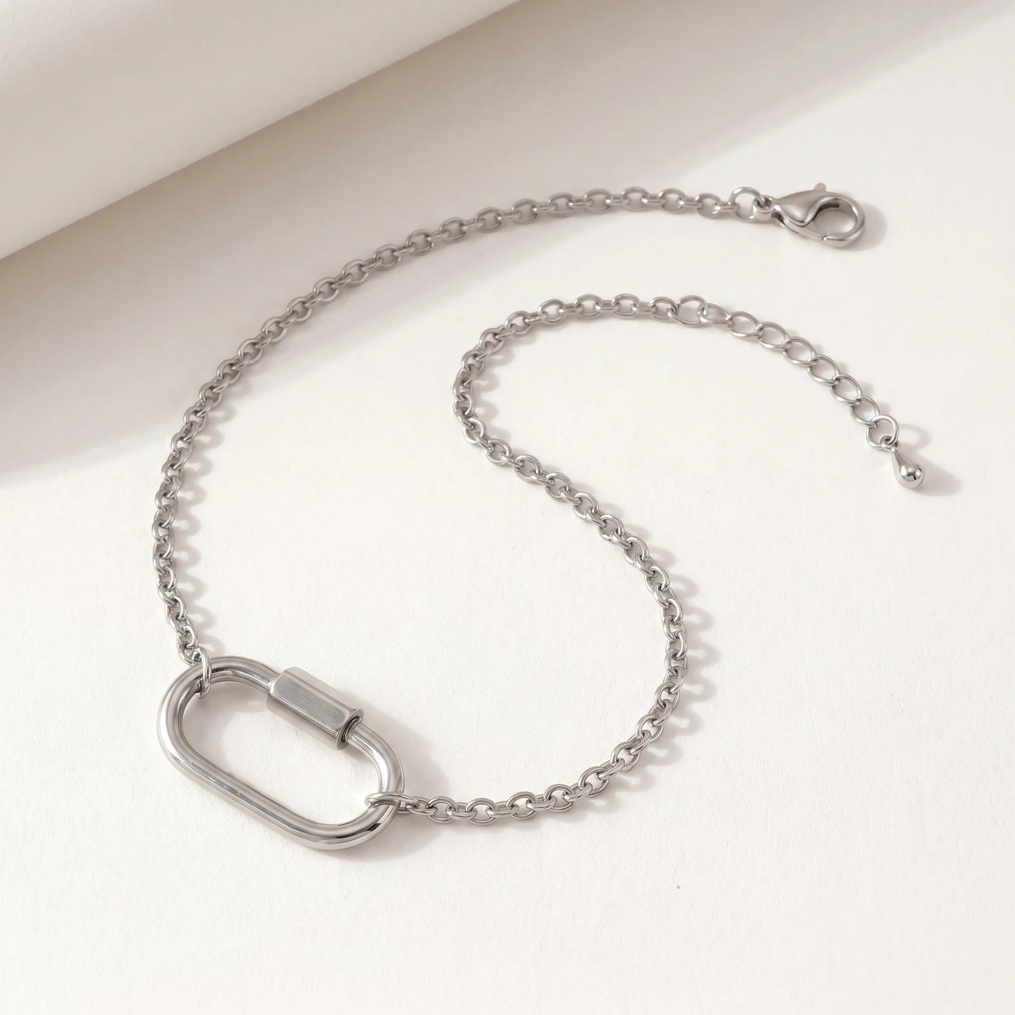 Silver cable chain bracelet with oval carabiner lock pendant - packshot stainless steel with 3cm cable extender