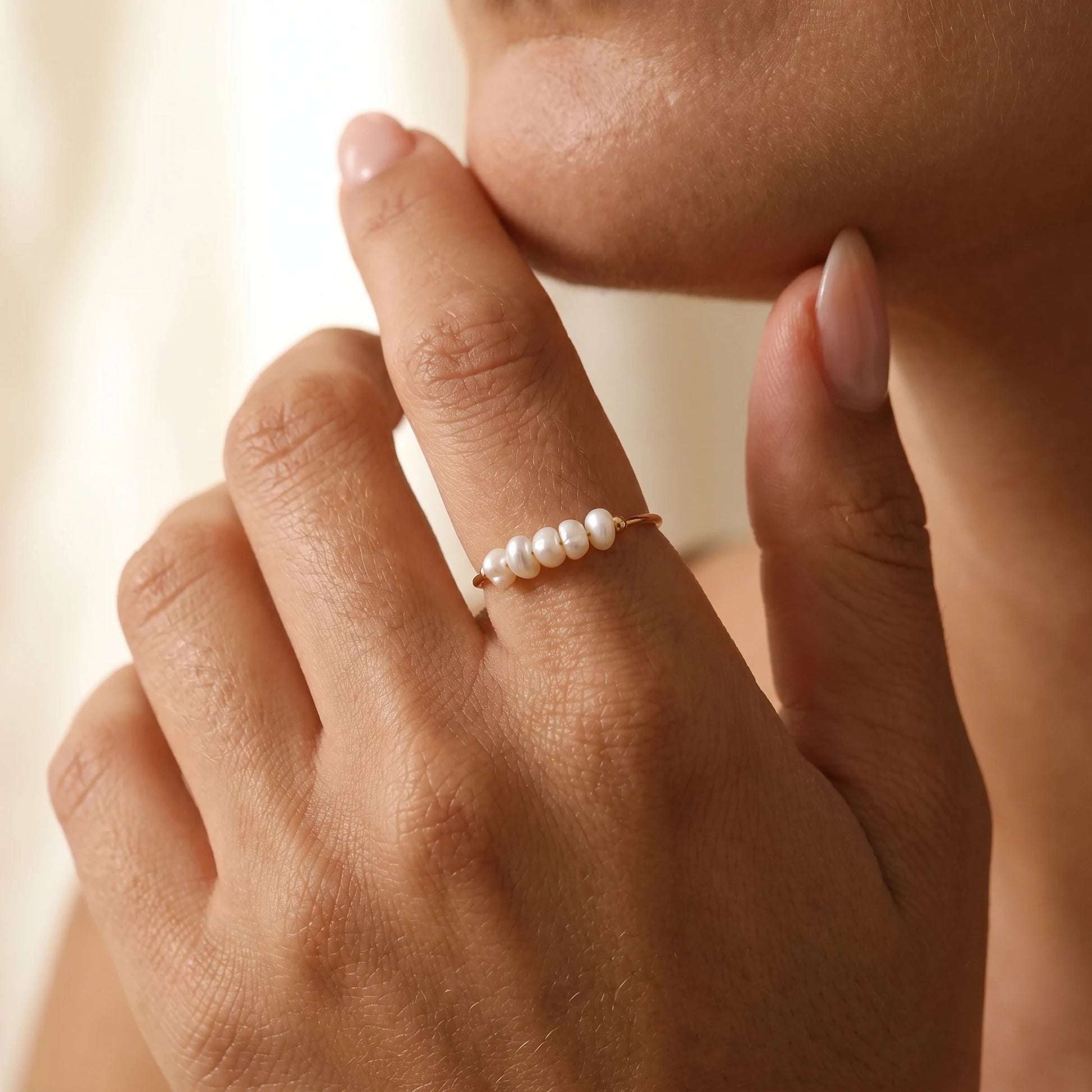 Gold Dainty Pearl Bar Ring worn on olive-skin hand showing five baroque freshwater pearls