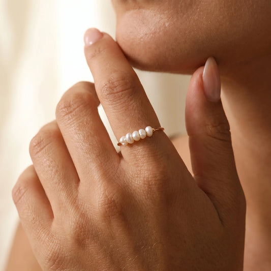 Gold Dainty Pearl Bar Ring worn on olive-skin hand showing five baroque freshwater pearls