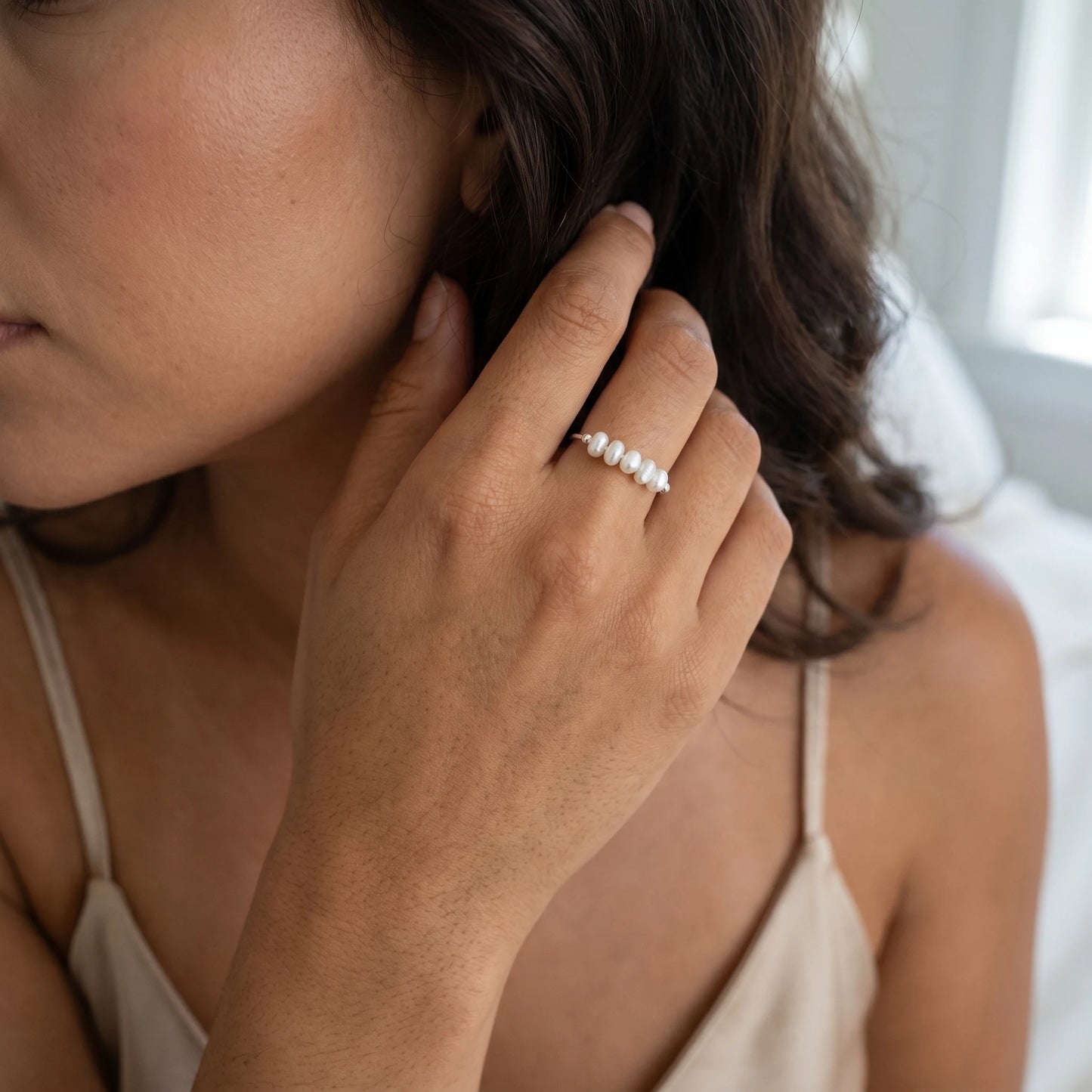 Silver Dainty Pearl Bar Ring on hand touching hair cream silk slip