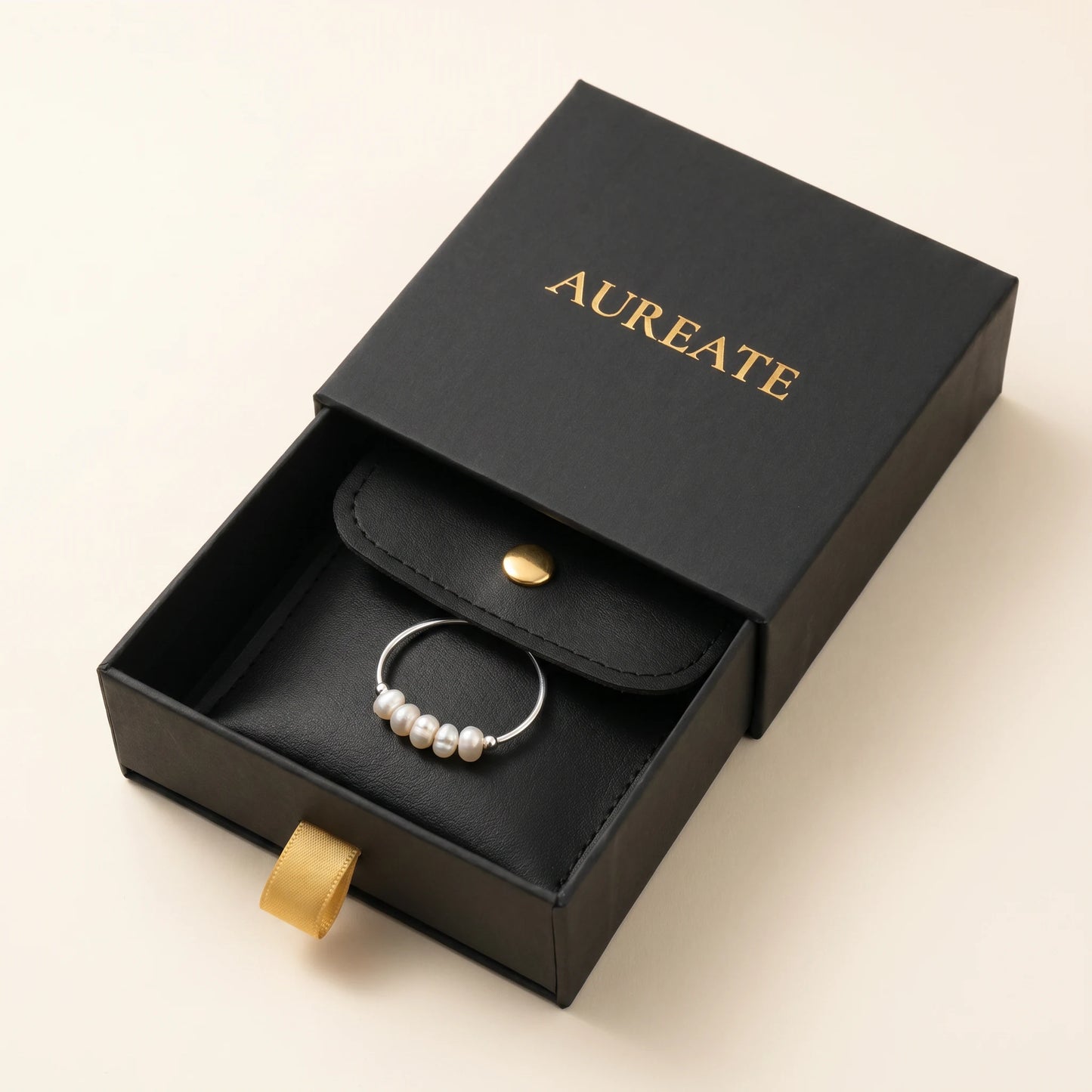 AUREATE gift box with Silver Dainty Pearl Bar Ring inside black leather pouch gold logo