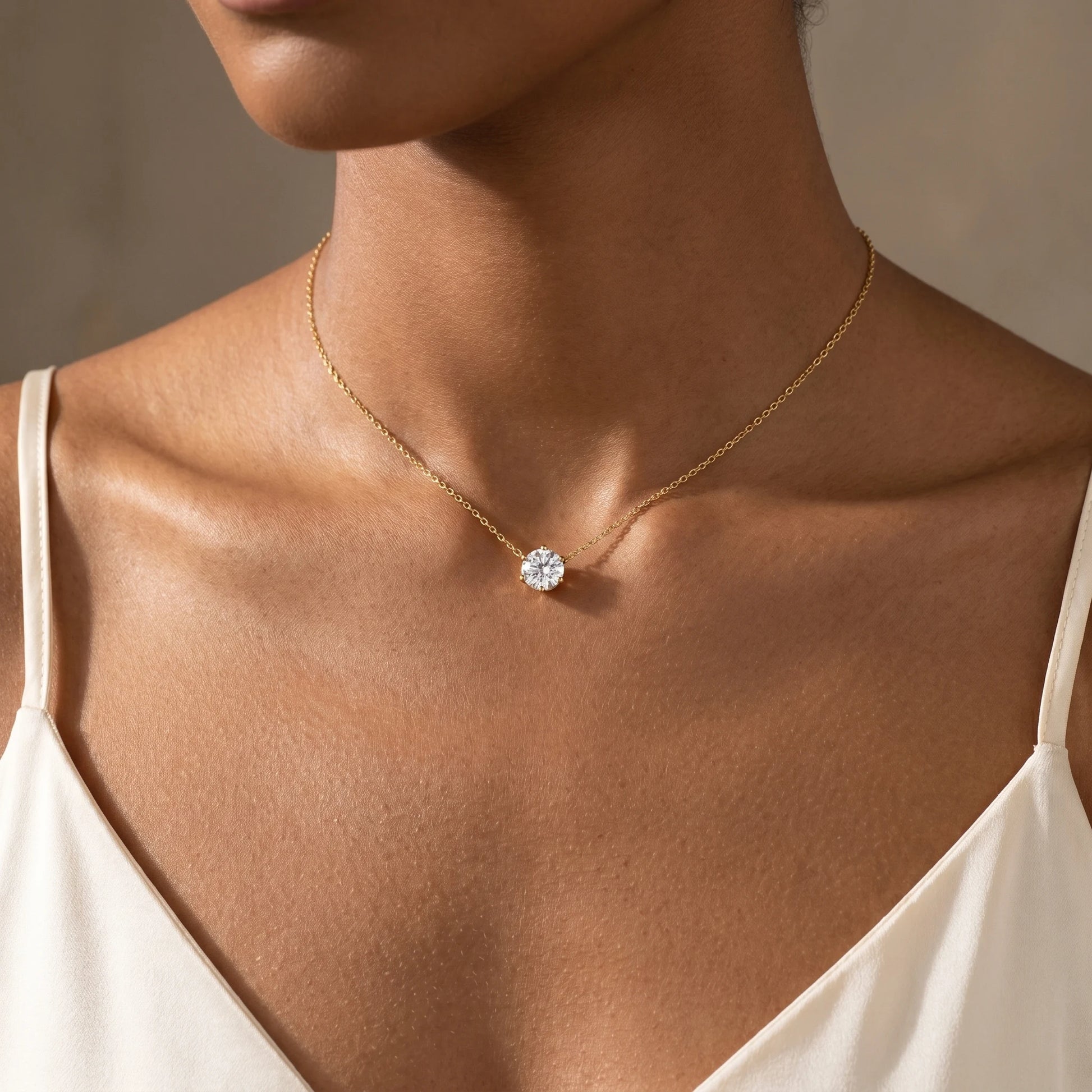 Floating Solitaire Necklace Gold worn at base of throat on woman in ivory camisole