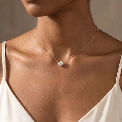 Floating Solitaire Necklace Gold worn at base of throat on woman in ivory camisole