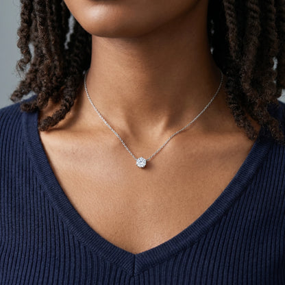 Floating Solitaire Necklace Silver Tone worn at throat on woman in navy V-neck