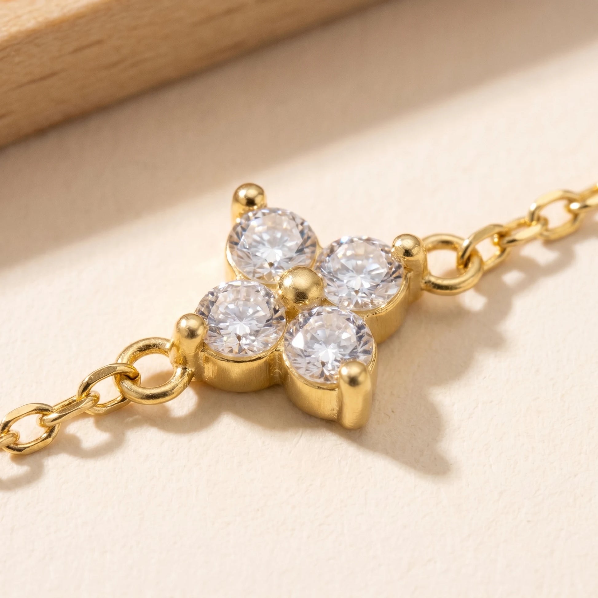 Gold clover charm macro detail 4 cubic zirconia stones