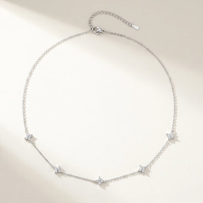 Silver clover station necklace packshot flat-lay 5 charms