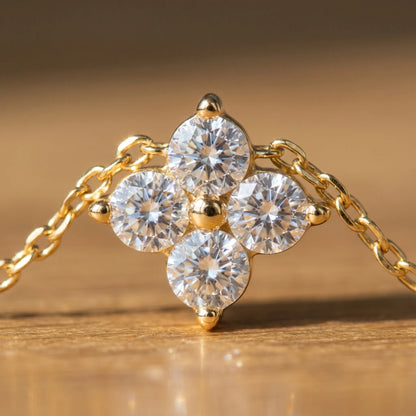 Diamond cluster necklace gold macro detail 4 brilliant CZ stones 3-prong