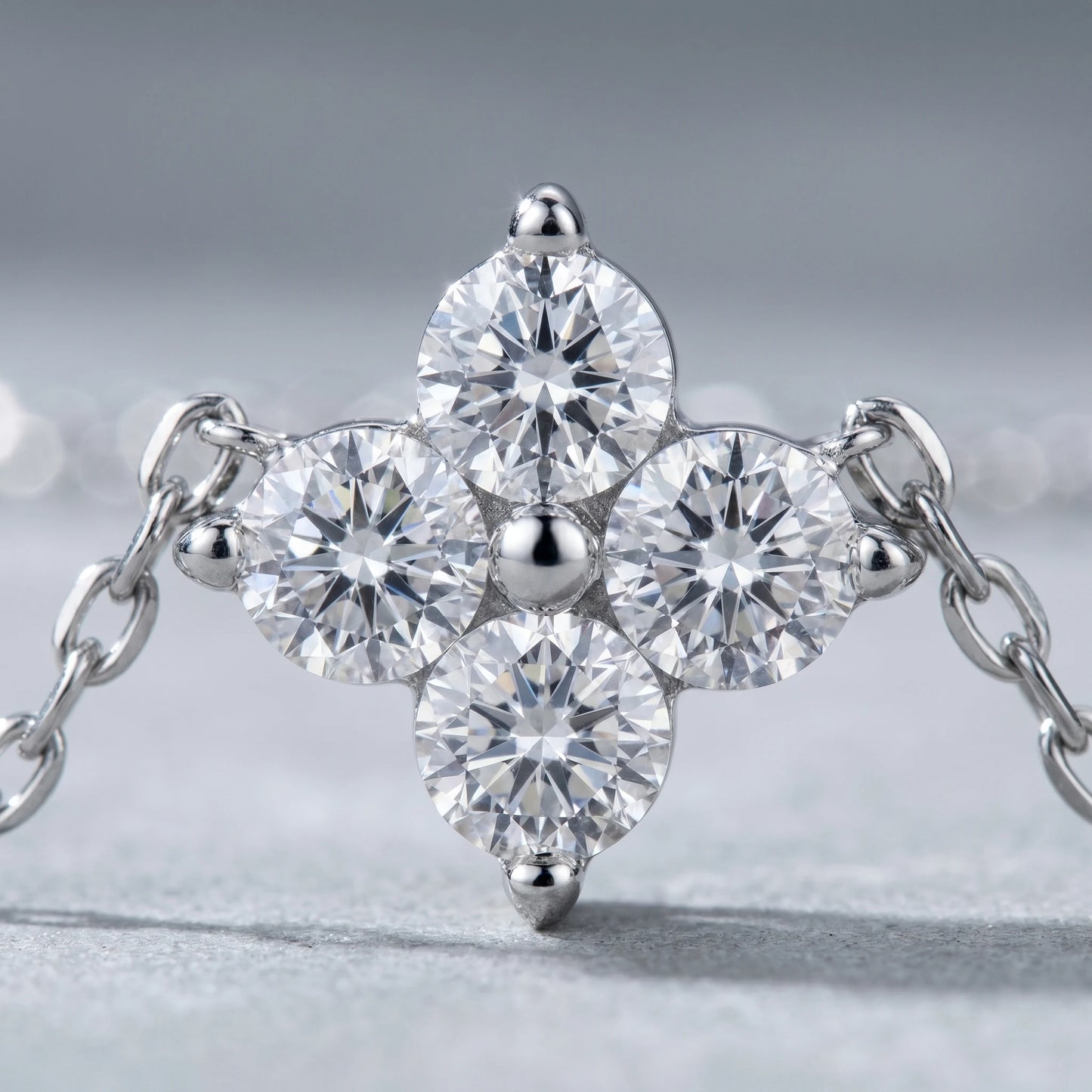 Diamond cluster necklace silver macro detail 4 brilliant CZ stones 3-prong