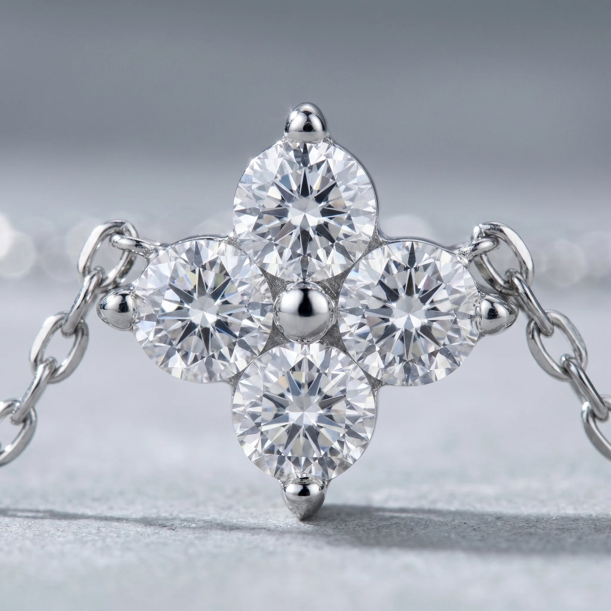 Diamond cluster necklace silver macro detail 4 brilliant CZ stones 3-prong