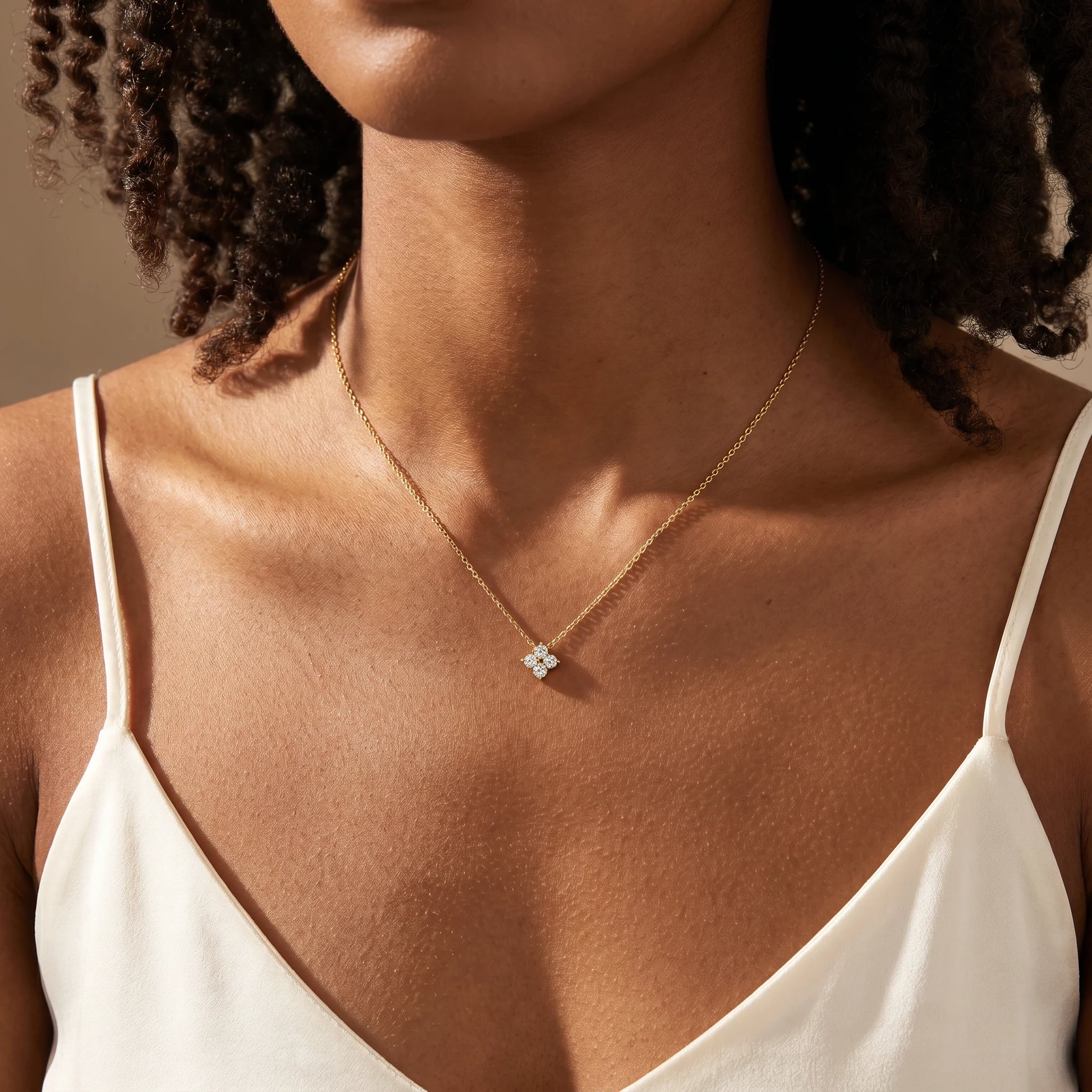 Diamond cluster necklace gold worn close-up dainty CZ pendant