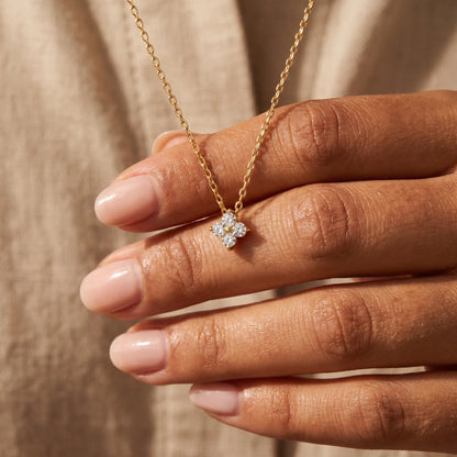 Diamond cluster necklace gold hand held intimate close up