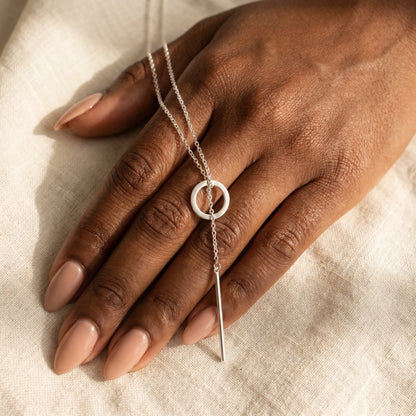 Silver Y-lariat necklace hand held intimate dark skin cream linen no clasp