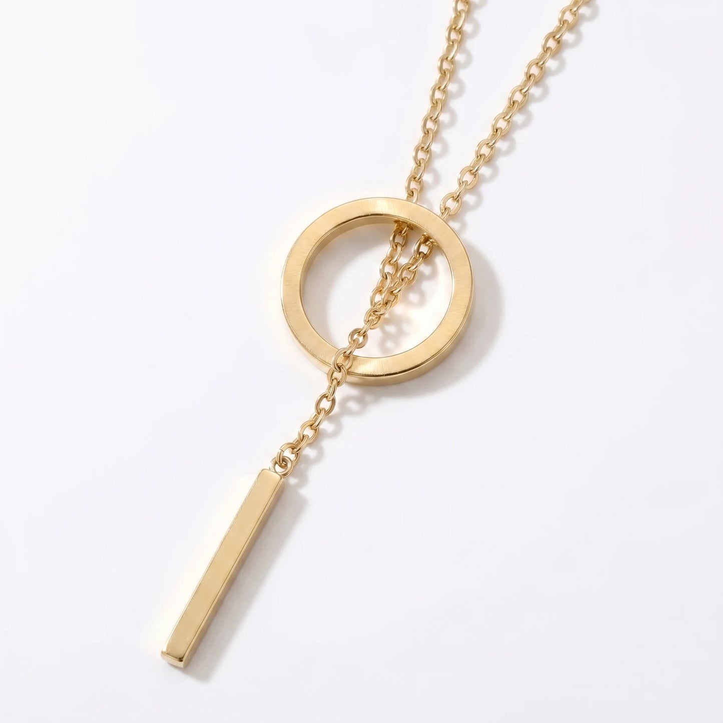 Gold Y-lariat necklace open circle macro detail showing chain threading through