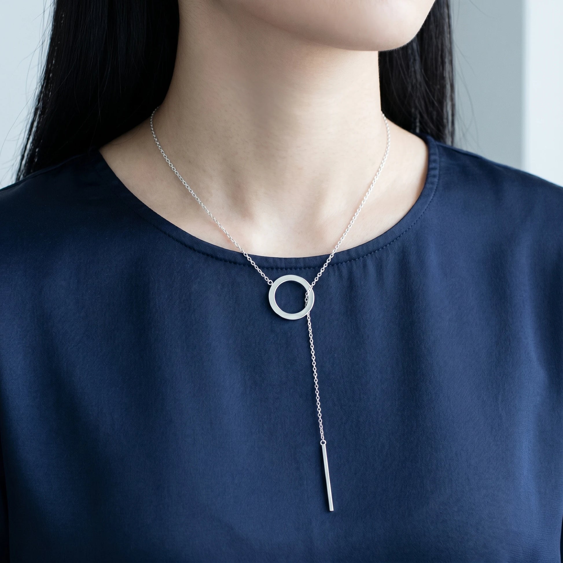 Silver Y-lariat necklace worn on Korean woman navy silk asymmetric slip-through