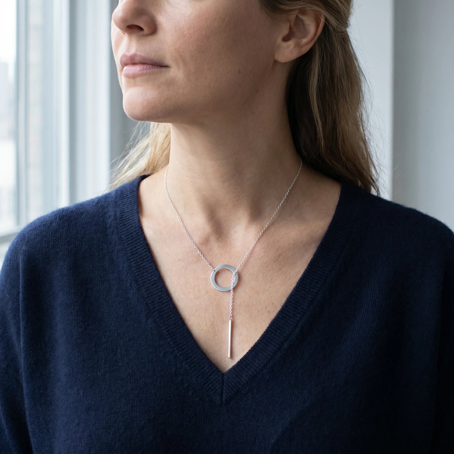 Silver Y-lariat necklace 3/4 portrait navy V-sweater SoHo loft asymmetric