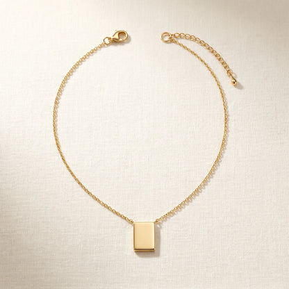 Gold rectangle pendant necklace packshot sharp corners extension chain properly attached