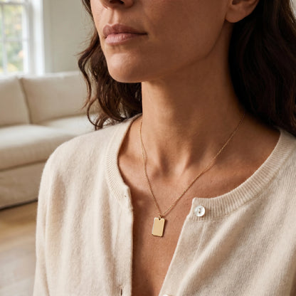 Gold rectangle pendant necklace 3/4 portrait editorial cream cashmere