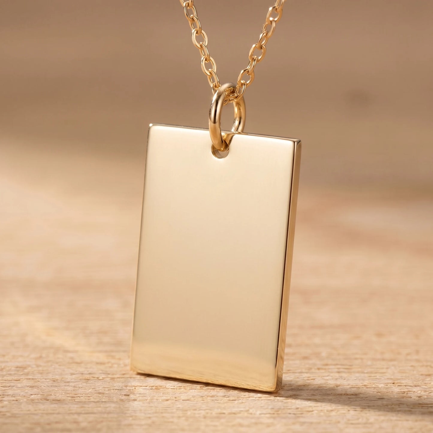 Gold rectangle pendant macro detail polished blank front sharp orthogonal corners