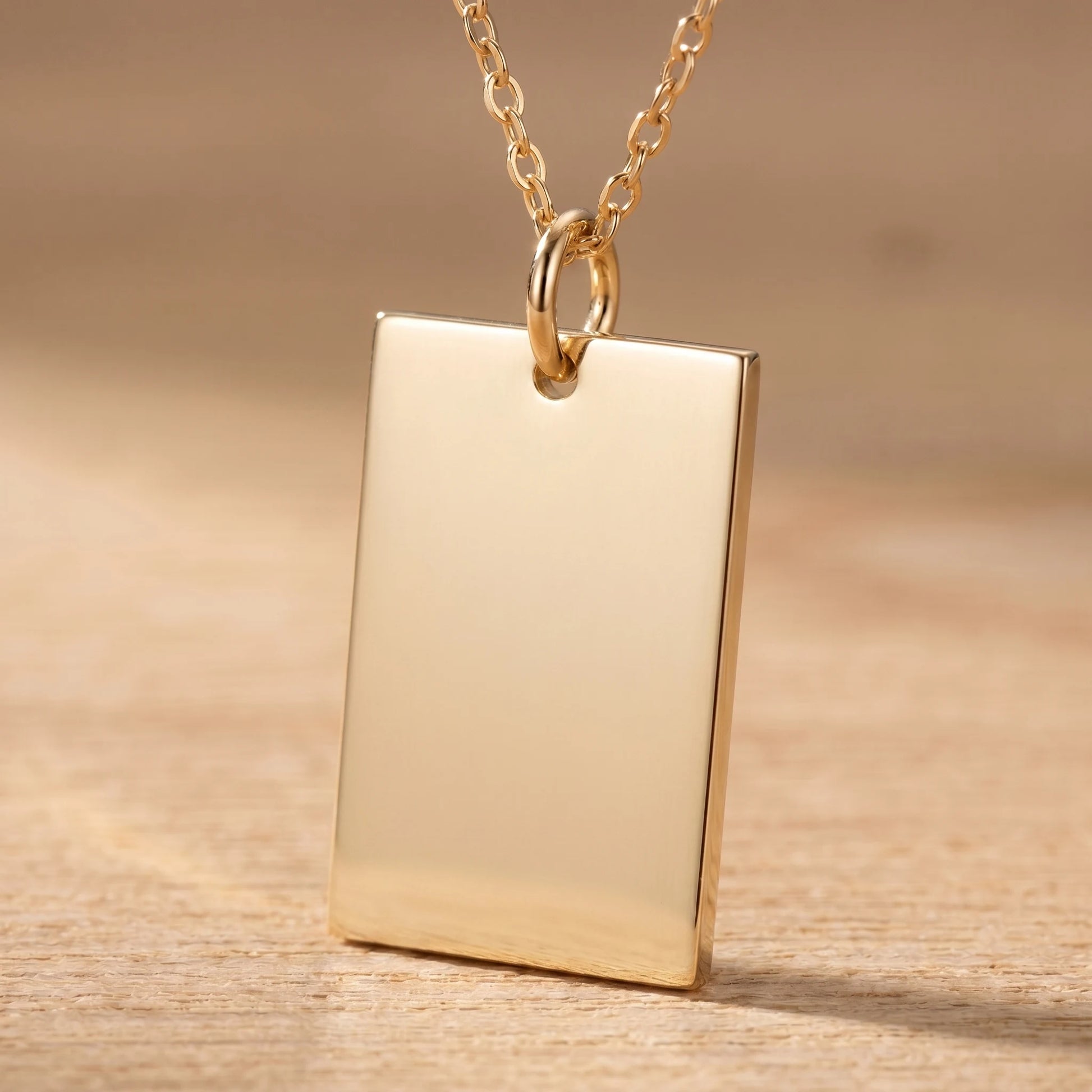 Gold rectangle pendant macro detail polished blank front sharp orthogonal corners