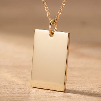 Gold rectangle pendant macro detail polished blank front sharp orthogonal corners