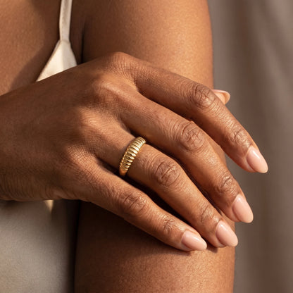 Dainty croissant dome ring gold worn on hand close-up