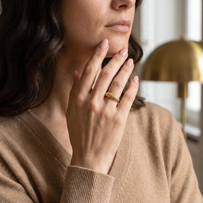 Dainty croissant dome ring gold mature woman hand near neck