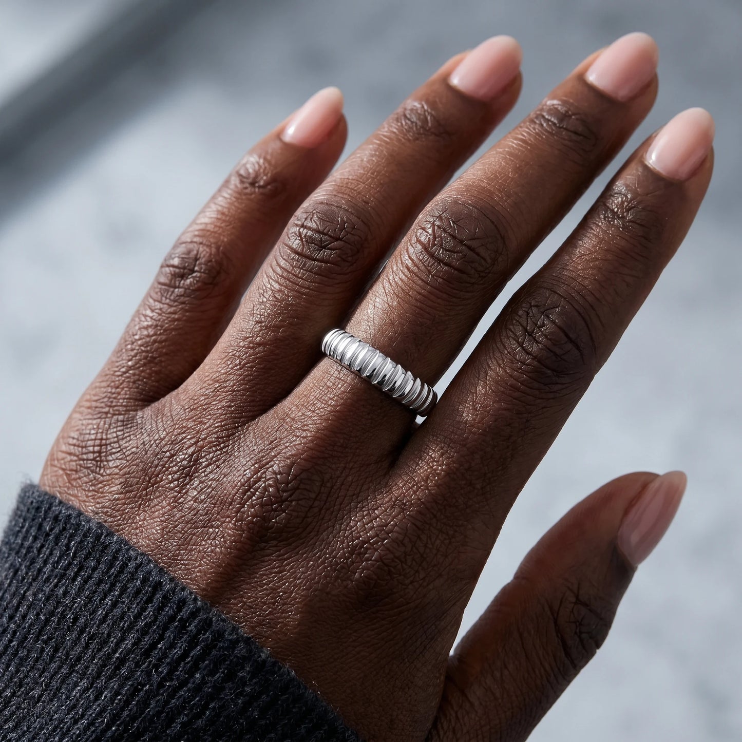 Dainty croissant dome ring silver worn on hand close-up