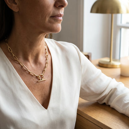 Paperclip toggle necklace gold three-quarter portrait Vogue editorial