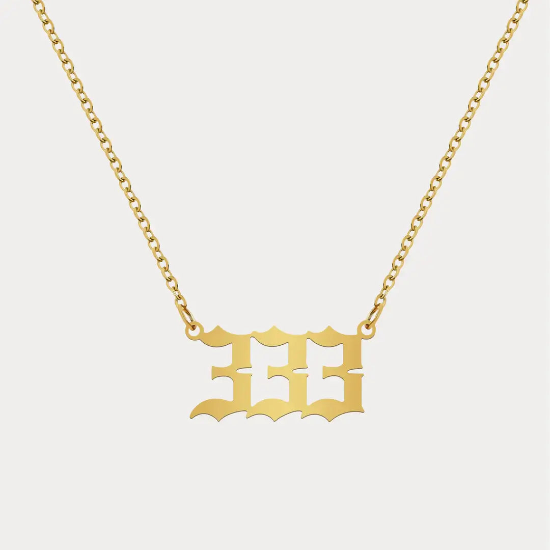 Angel Number Pendant Necklace by AUREATE featuring a gold 333 charm on a delicate chain.