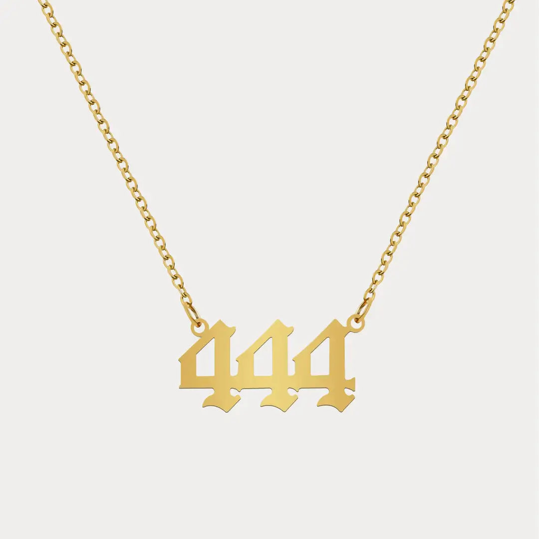 Angel Number Pendant Necklace by AUREATE featuring a gold chain with the number 444 as the centerpiece.