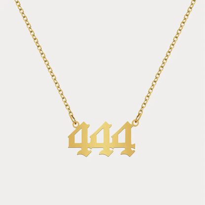 Angel Number Pendant Necklace by AUREATE featuring a gold chain with the number 444 as the centerpiece.